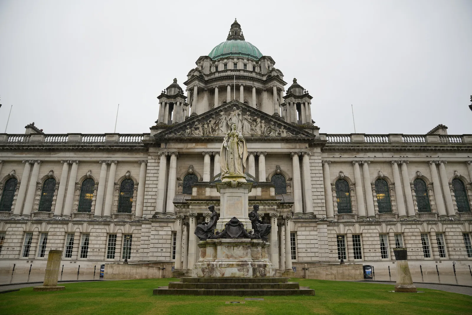 Front view of Belfast City Hall showcasing its architectural grandeur and historic statue.